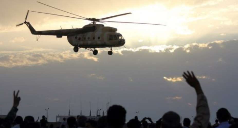 A helicopter flies over Benghazi during a military display.  By Abdullah Doma AFPFile
