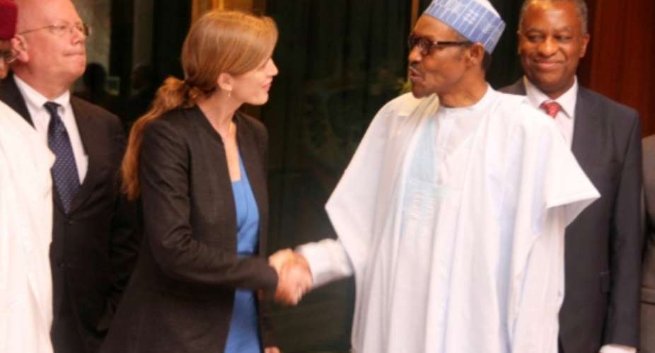 Nigerian President Mohammadu Buhari shakes hand with the US Permanent Representative to the UN Samantha Power in Abuja, Nigeria on April 21, 2016.  By Philip Ojisua (AFP/File)