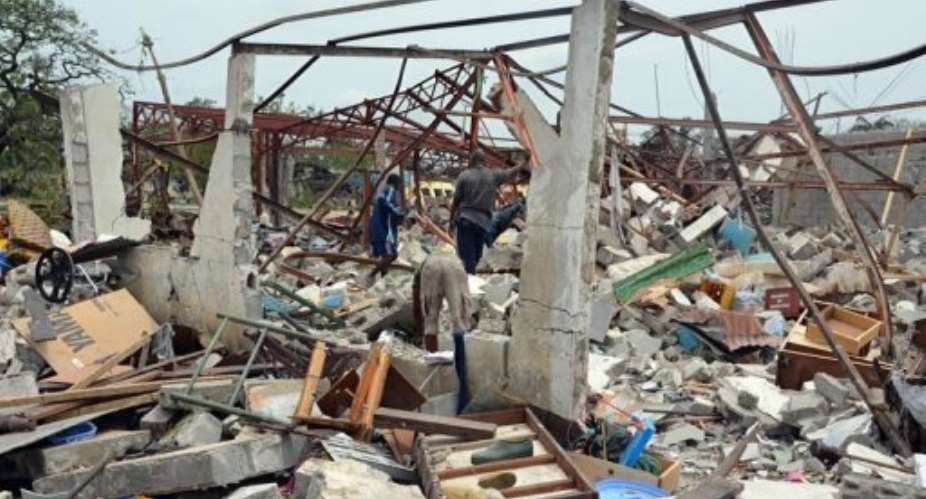 Congo has issued a plea for international help as soldiers recovered bodies of those killed in the blasts.  By Patrick Fort (AFP)