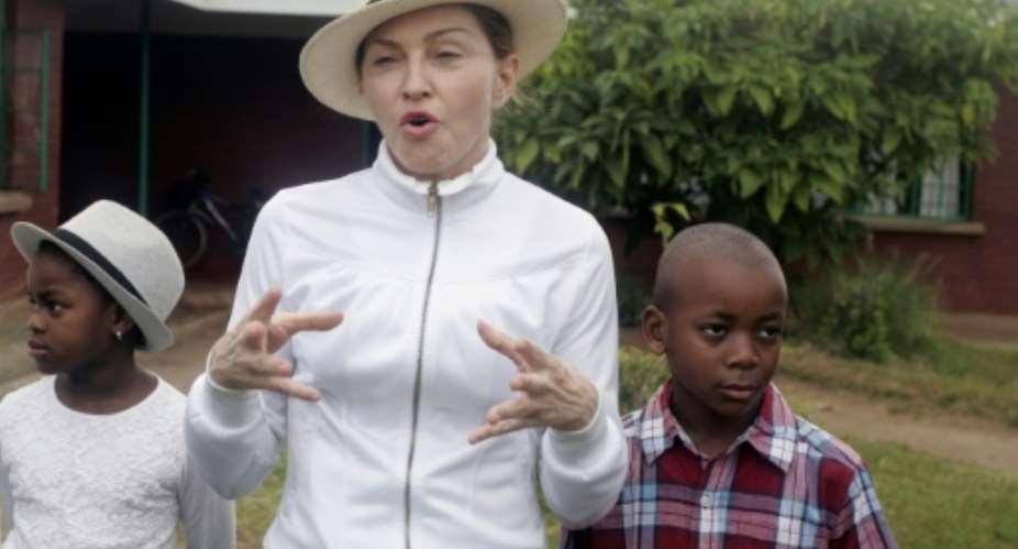 US Pop Star Madonna adopted Malawian children David Banda R in 2006 and Mercy James L in 2009.  By AMOS GUMULIRA AFPFile