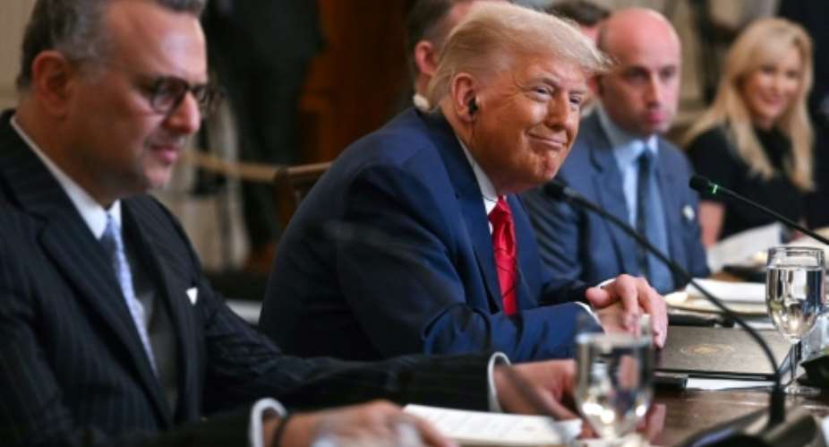 US President Donald Trump, flanked by US Senior Advisor for Africa Massad Boulo and White House Deputy Chief of Staff Stephen Miller, participates in a multilateral lunch with visiting African Leaders in the State Dining Room of the White House.  By Jim WATSON (AFP/File)