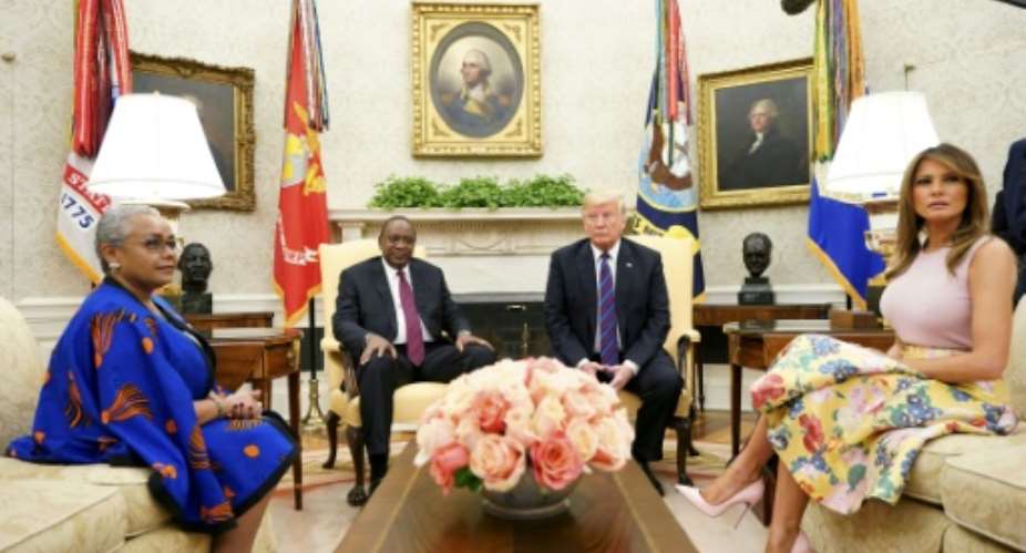 US President Donald Trump, right, Kenya's President Uhuru Kenyatta and their wives Melania Trump and Margaret Kenyatta meet in the White House Oval Office.  By MANDEL NGAN AFP