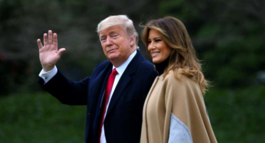 US President Donald Trump waves next to First Lady Melania Trump as they walk to Marine One before departing from the South Lawn of the White House.  By ANDREW CABALLERO-REYNOLDS AFP