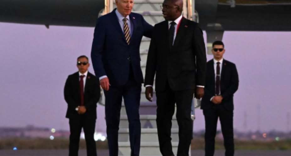 US President Joe Biden (3rd R) met with Angolan Foreign Affairs Minister Tete Antonio (2nd R) upon his arrival in Luanda.  By ANDREW CABALLERO-REYNOLDS (AFP)