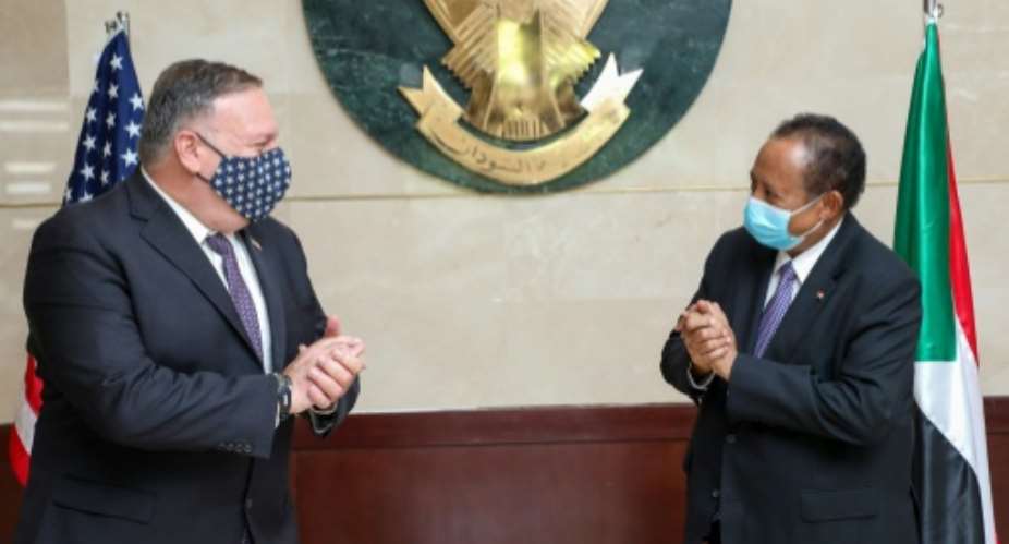US Secretary of State Mike Pompeo L visited Prime Minister Abdalla Hamdok R of Sudan in August as the legislation was being prepared.  By Handout Office of Sudan's Prime MinisterAFPFile