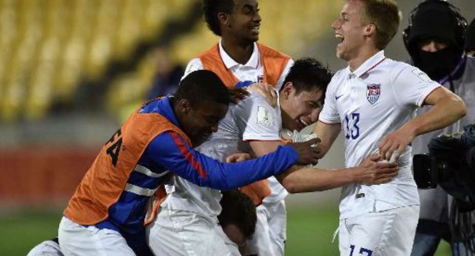 Thomas Thompson R of the US celebrates with teammates after victory over Colombia during their FIFA Under-20 World Cup round of 16 football match at Wellington Regional Stadium in Wellington on June 10, 2015.  By Marty Melville AFP
