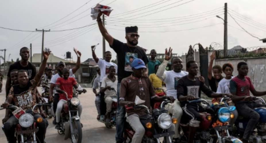 US-Nigerian musician Olubankole Wellington, popularly known as Banky W., rode with supporters in a line of motorcycles during a campaign rally in Lagos.  By FLORIAN PLAUCHEUR AFP