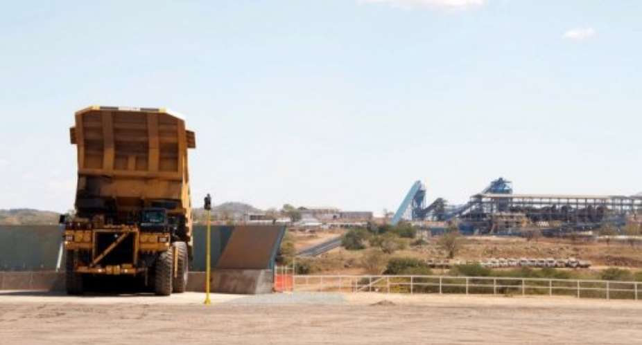 A truck dumps a coal onto a conveyer belt at Vales Moatize mine in northern Mozambique on May 8, 2011.  By Johannes Myburgh (AFP)