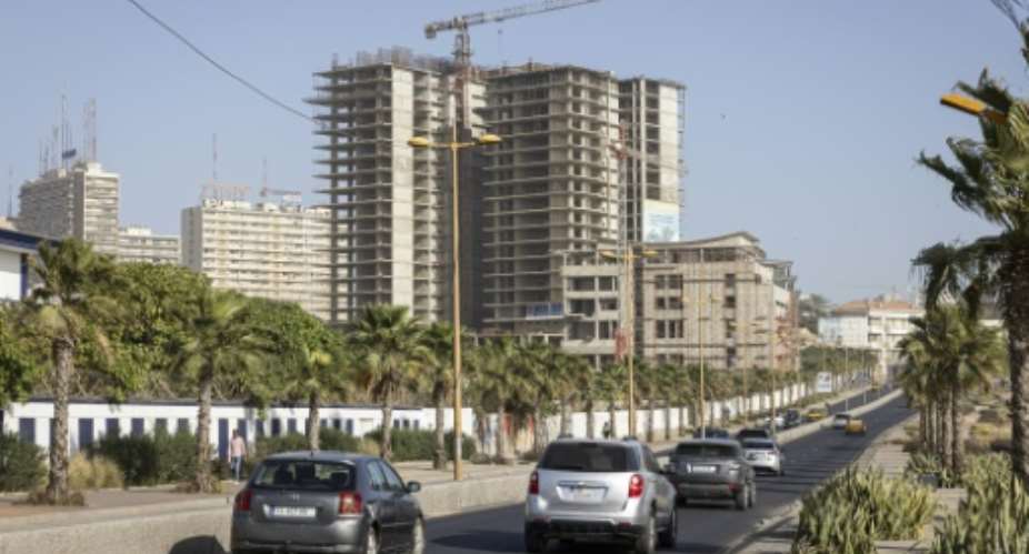 Vehicles drive along the Corniche in Dakar, Senegal, whose new loan with the IMF totals $2.2 billion.  By PATRICK MEINHARDT (AFP/File)