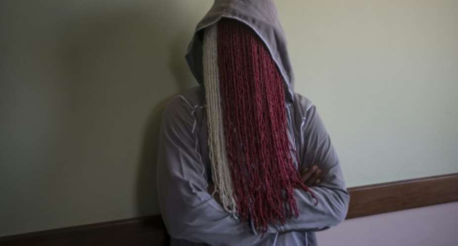 Veiled: Ghanaian investigative journalist Anas Aremeyaw Anas poses during an interview with AFP. His latest investigative documentary, 'Number 12', has led to the dissolution of the Ghana Football Association and the resignation of its boss.  By CRISTINA ALDEHUELA AFP