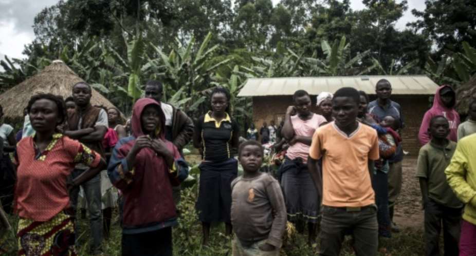 Villagers gathered around the body of a suspected Ebola victim in Beni, in DR Congo's restive east.  By John WESSELS AFP