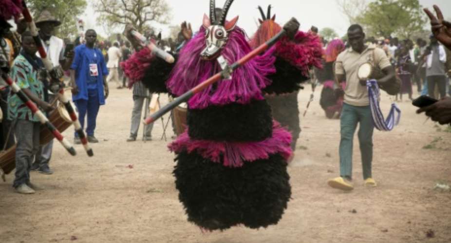 Villagers in Burkina Faso celebrate Festimasq in the remote town of Pouni.  By FANNY NOARO-KABR AFP