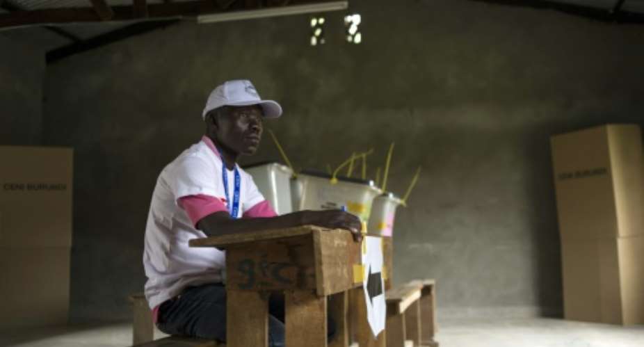 A worker from the electoral commission waits in an empty polling station in Bujumbura on June 29, 2015 as local and parliamentary elections begin with a small voter turnout.  By Phil Moore AFP