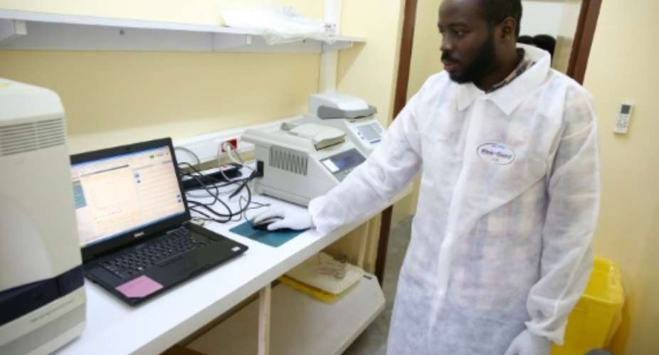 Viral sleuth: doctor Illich Mombo analyses the results of an Ebola test at the Franceville International Centre for Medical Research.  By STEVE JORDAN AFP