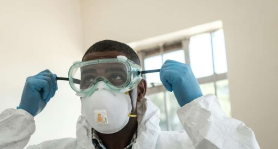 Virus threat: A lab technician gears up for visiting a quarantine ward at the Kenyatta National Hospital in Nairobi.  By Yasuyoshi CHIBA AFP