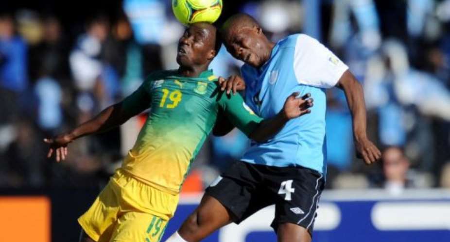 Nomuethe Eugene of South Africa L and Mmusa Ohilwe R of Botswana vie for the ball.  By Monirul Bhuiyan AFP