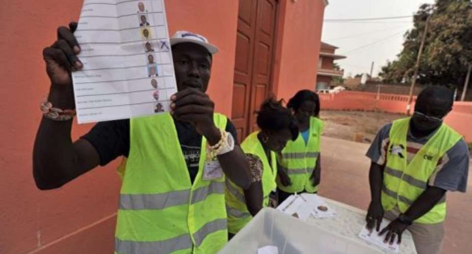Electoral officers count ballot papers at the polling station in Bissau.  By Issouf Sanogo AFP