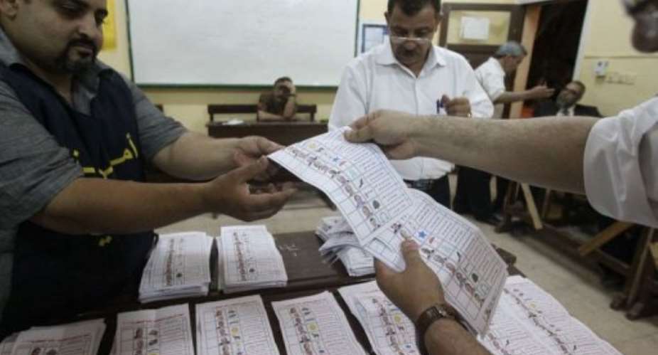 Egyptian election officials count ballots at a polling station in Cairo.  By Khaled Desouki AFP