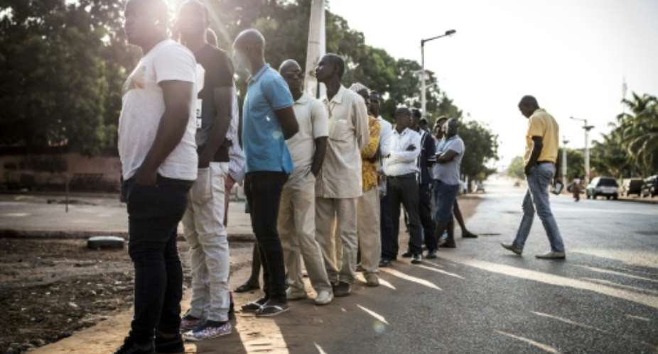 Voters line up at polls in Guinea-Bissau, where a presidential election is hoped to break a long-running deadlock.  By JOHN WESSELS AFP