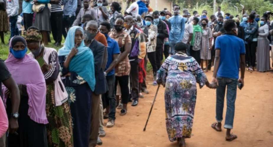 Voters queue at a polling station in Magere, Uganda.  By Yasuyoshi Chiba AFP