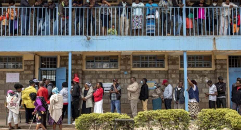Voters queue at a school in the poor Dandora neighbourhood of Nairobi.  By Patrick Meinhardt AFP