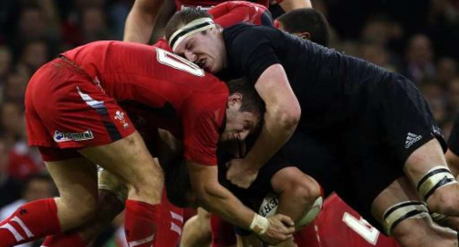 Wales' fly-half Dan Biggar L and New Zealand's lock Brodie Retallick fight for the ball during their Autumn International rugby union Test match, at the Millennium Stadium in Cardiff, south Wales, on November 22, 2014.  By Geoff Caddick AFPFile