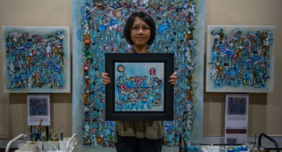 Wan Jamila Wan Shaiful Bahri, 17, from Malaysia, spent lockdown painting her Our Heroes series in tribute to front-line workers.  By Mohd RASFAN AFP