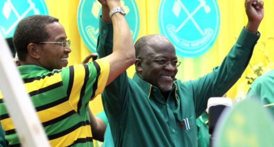 President Jakaya Kikwete left congratulates John Magufuli in Dodoma on July 12, 2015, on his nomination as the ruling Chama Cha Mapinduzi party's presidential candidate for the October elections.  By Stringer AFP