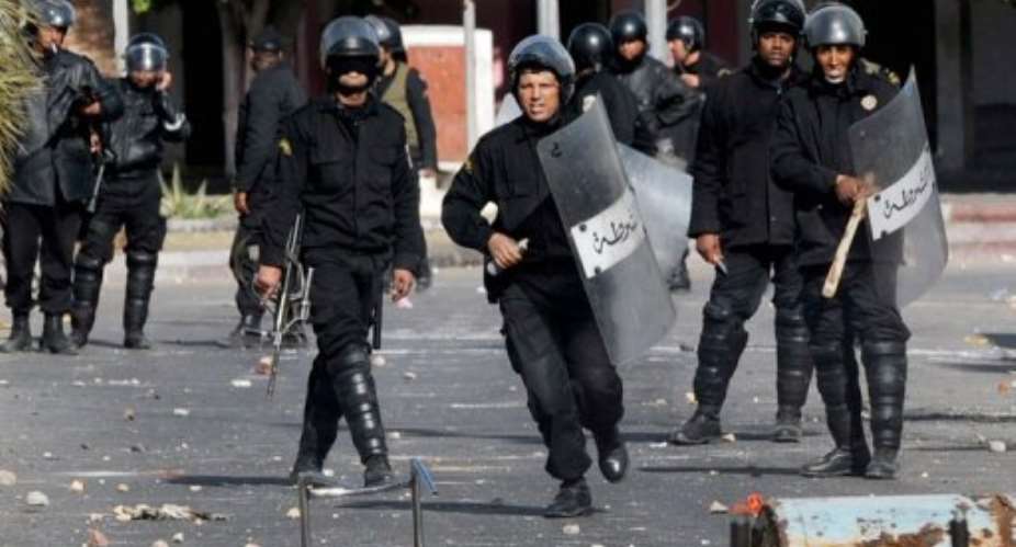 Tunisian security forces personnel react during clashes with demonstrators in Regueb near Sidi Bouzid.  By Str (AFP/File)