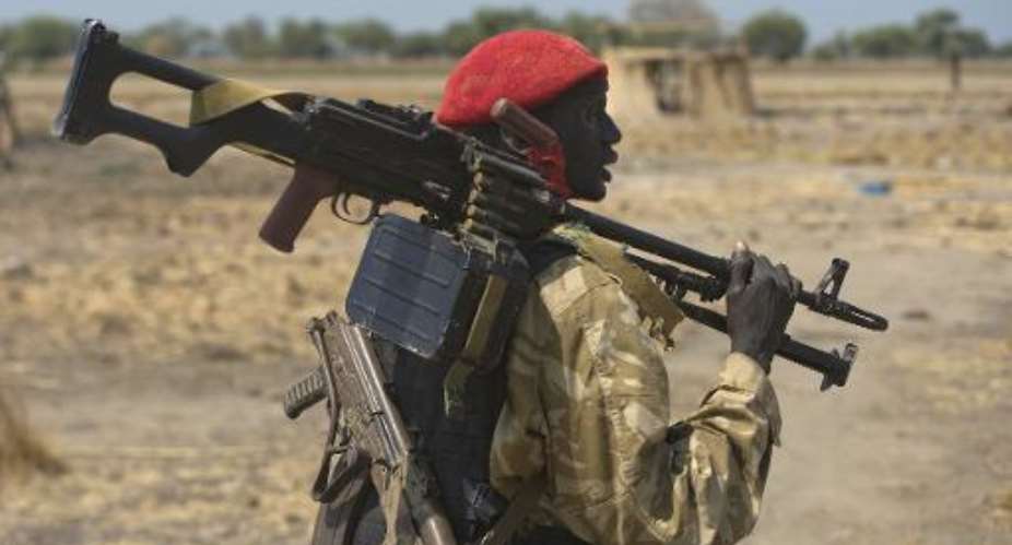 An armed South Sudanese government soldier stands near a village in Bor on January 26, 2014.  By Ali Ngethi AFPFile