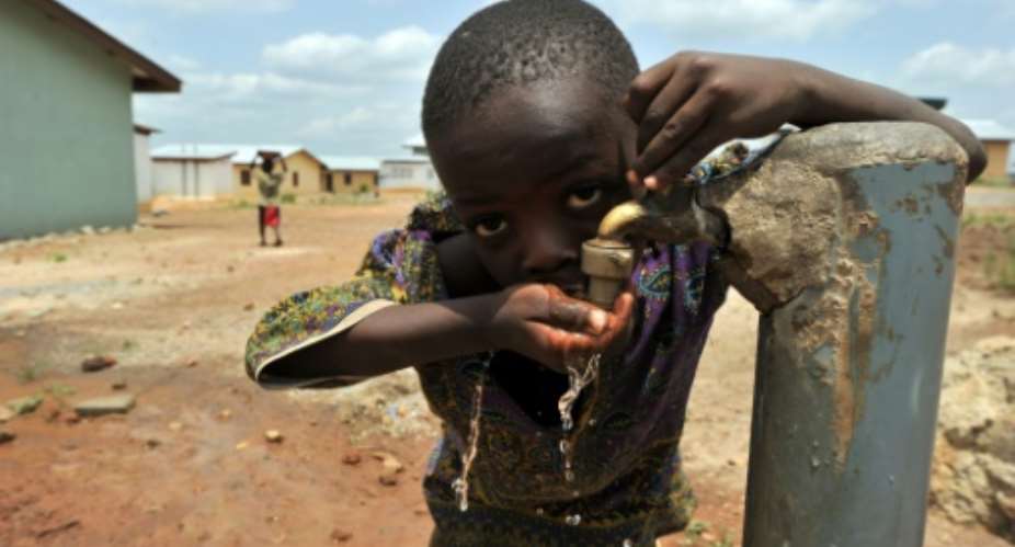 A boy drinks from a water tap in eastern Sierra Leone.  By Issouf Sanogo AFPFile