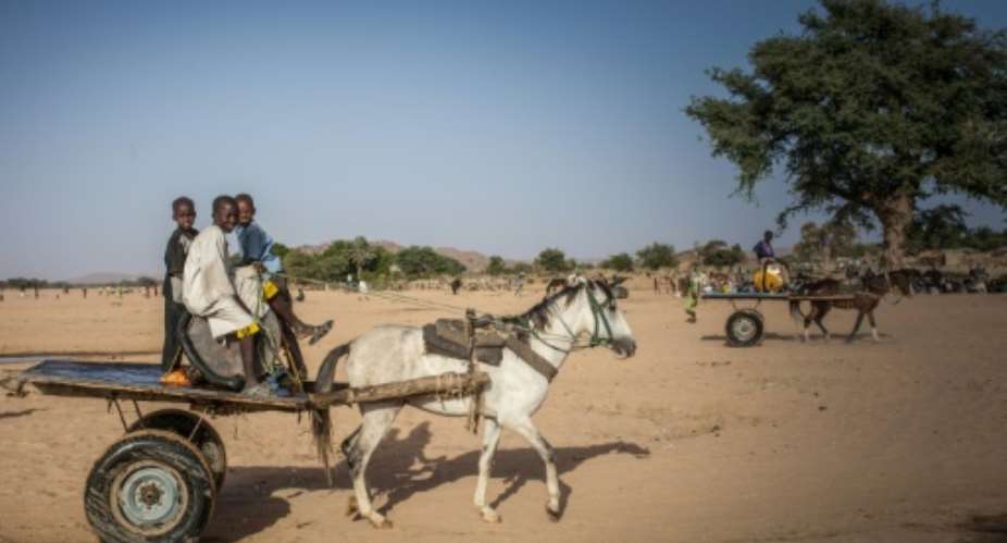 Water vendors in the arid Ouaddai district of Chad travel back and forth between meagre supplies and needy folk in town.  By Amaury HAUCHARD AFPFile