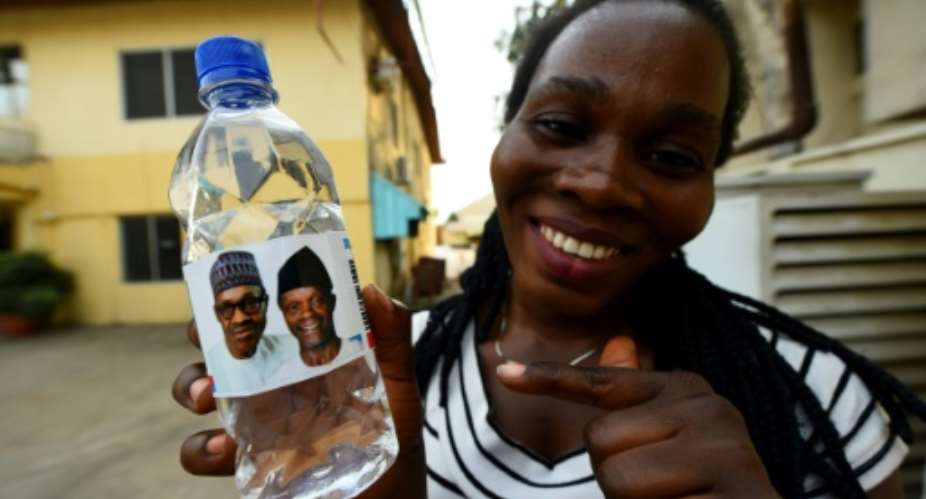 Water works? Bottled water bearing the image of Nigeria's President Mohammadu Buhari and his vice president ahead of Saturday's rescheduled elections.  By Pius Utomi EKPEI AFPFile