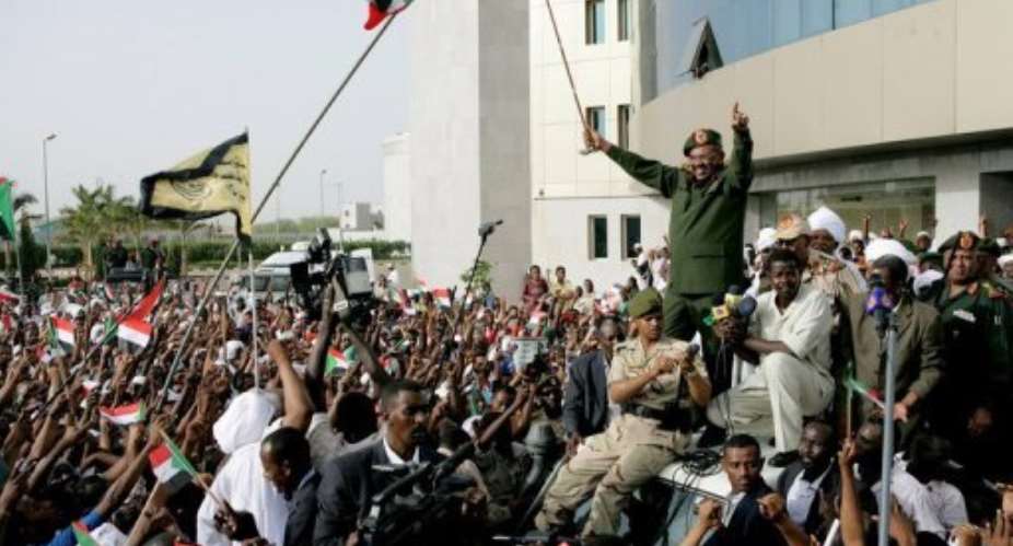 Sudanese President Omar al-Bashir waves to the crowd gathering outside the Defence Ministry in Khartoum.  By Ashraf Shazly AFP