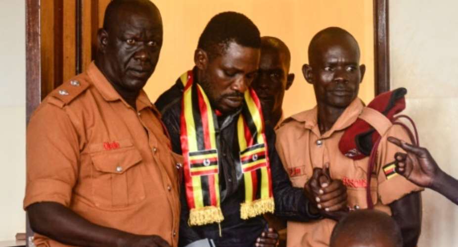 Wearing a scarf with the Ugandan colours, Kyagulanyi appeared last week at the chief magistrate court in Gulu, northern Uganda to face treason charges.  By STRINGER AFP