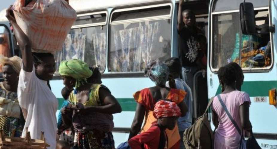 Women get on a bus to flee Bissau following a coup in April 2012.  By Seyllou (AFP/File)