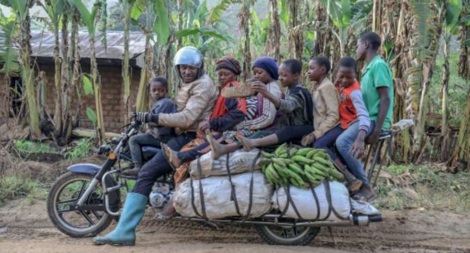 What, no kitchen sink? A giant motorbike in Cameroon takes a driver, six passengers and plenty of luggage.  By Daniel Beloumou Olomo AFP