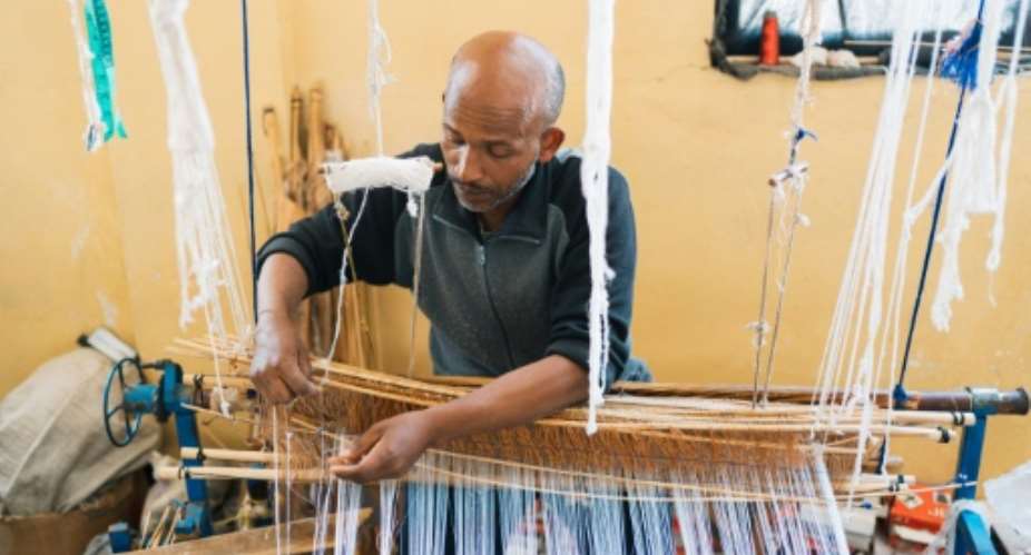 What we produce with so much effort can now be made instantly by machines, says Getu Derza, who began crafting habesha kemis dresses when he was 14.  By Sehin Tewabe (AFP)