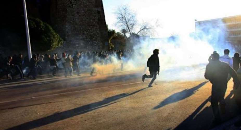 Tunisian inhabitants of Sidi Bouzid clash with security forces in front the government palace in Tunis in January.  By  (AFP/File)