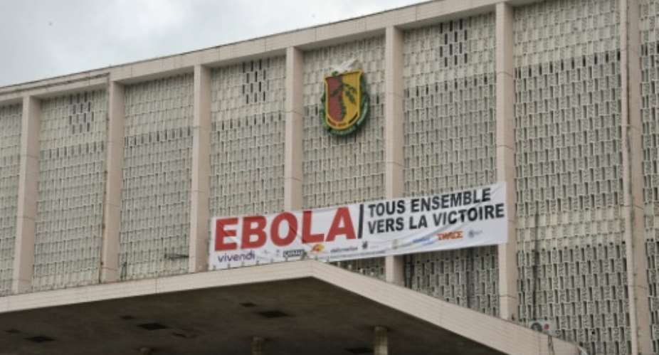 A banner reading in French, Ebola - All together for victory is pictured on September 26, 2015 in Conakry.  By Cellou Binani AFPFile