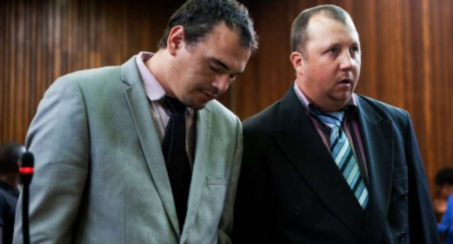 Willem Oosthuizen, left, and Theo Jackson, pictured on Monday, filmed themselves forcing a black man into a coffin and threatening to burn him alive.  By WIKUS DE WET AFPFile