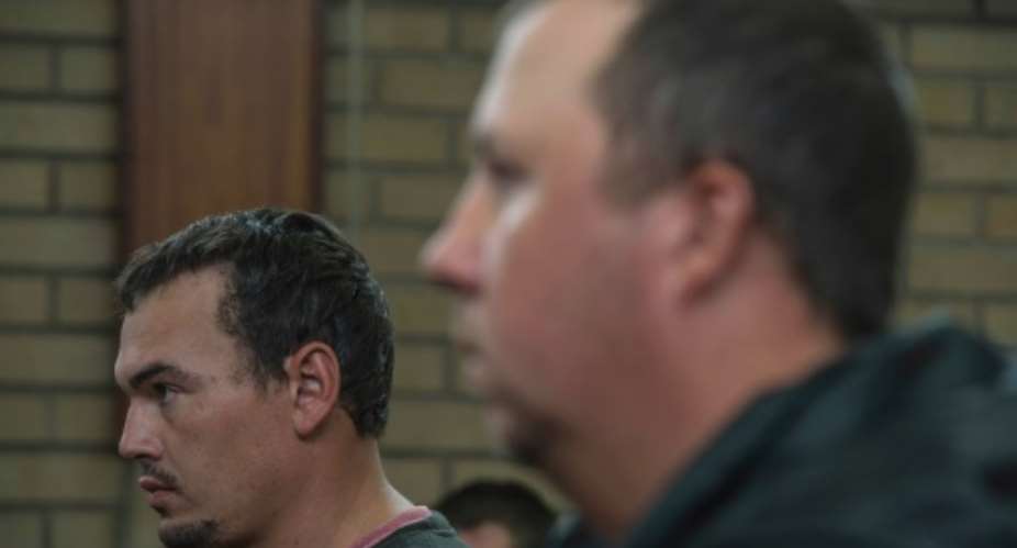 Willem Oosthuizen right and Theo Martins Jackson face charges of kidnapping and assaulting a colleague as they appeared at the Middleburg Magistrate Court on November 16, 2016.  By Mujahid Safodien AFPFile