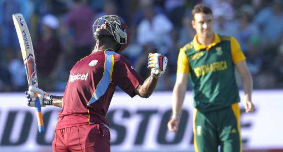 West Indies batsman Andre Russell L celebrates after they beat South Africa by one wicket during the fourth one-day international at St. George's Park in Port Elizabeth on January 25, 2015.  By Gianluigi Guercia AFP