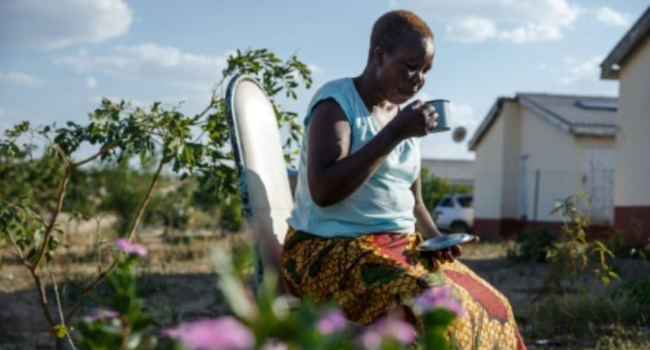 With medicine prices soaring, Alice Chenyika, 50, drinks herbal tea to control her blood pressure.  By Jekesai NJIKIZANA AFP