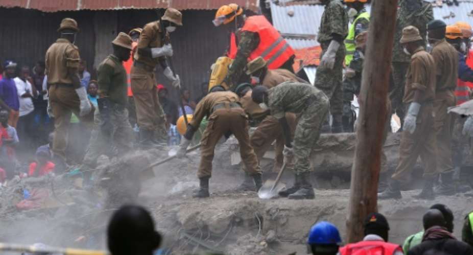 Rescue workers rake through the rubble of a six-storey building that collapsed killing at least 26 people in Nairobi's suburb of Huruma, on May 3, 2016.  By Simon Maina AFPFile