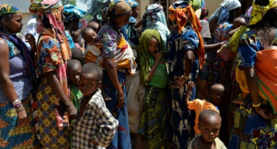 Women and children wait in line in the Begoua district, northeast of Bangui, to receive humanitarian and medical aid in 2014.  By MIGUEL MEDINA AFPFile