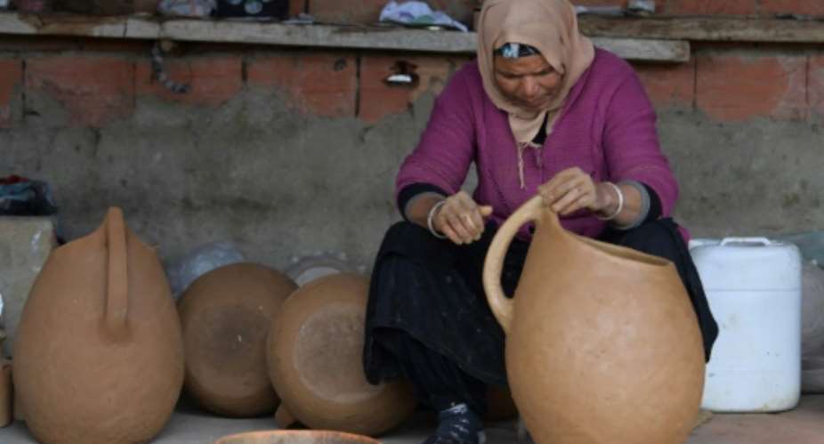 Women from Sejnane in northern Tunisia keep alive an ancient tradition of creating pottery with all-natural materials.  By FETHI BELAID AFP