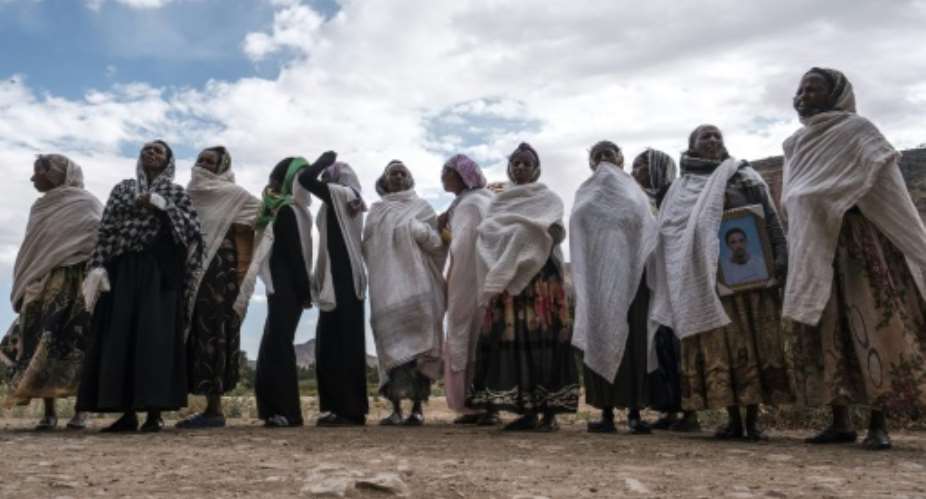 Women gather to mourn the victims of a massacre allegedly perpetrated by Eritrean soldiers in the village of Dengolat, north of Mekele, the capital of Tigray, on February 26, 2021.  By EDUARDO SOTERAS AFPFile
