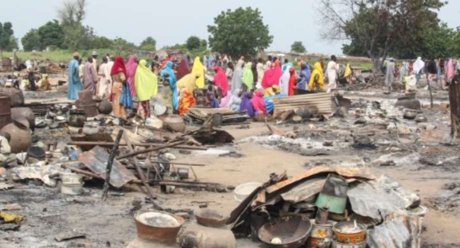 Women sift through the remains of a market blown up September 20, in Amarwa, near Borno state capital Maiduguri. Over 27,000 people have been killed in Borno and two neighbouring states since 2009, in one of the worlds most violent conflicts.  By AUDU MARTE (AFP/File)