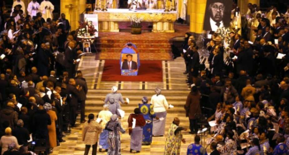 Women sing during the funeral ceremony of Congolese opposition leader Etienne Tshisekedi at the Koekelberg Basilica in Brussels, on February 9, 2017.  By NICOLAS MAETERLINCK (Belga/AFP)